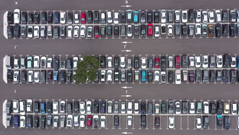 Right-to-left-aerial-traveling-over-a-cars-parked-in-a-parking-lot-France